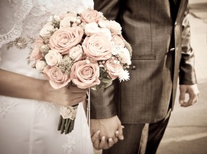 bride holding wedding bouquet and groom